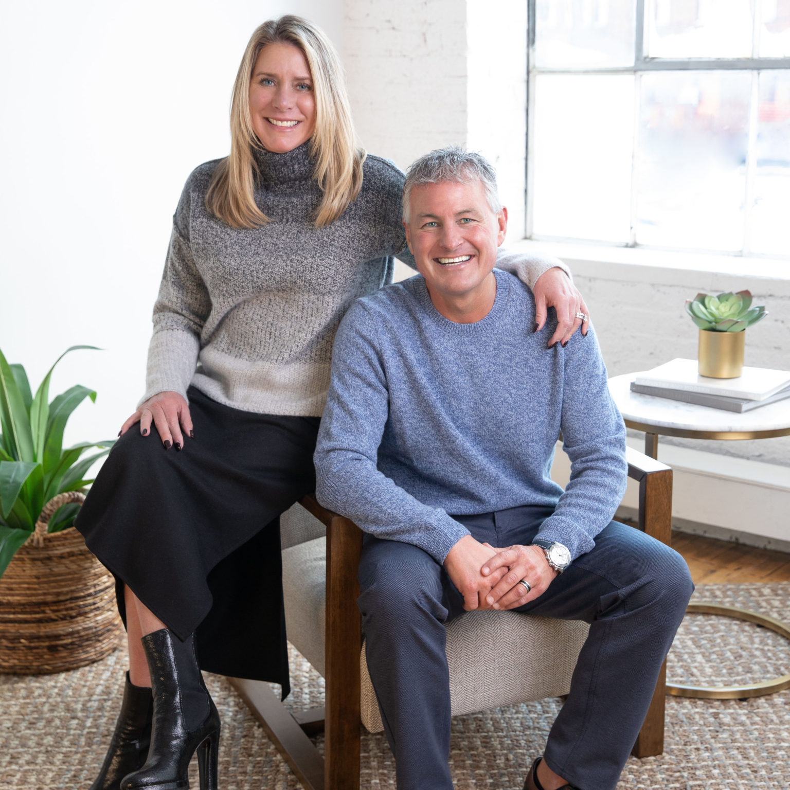 The Simnings smiling while sitting on a chair together